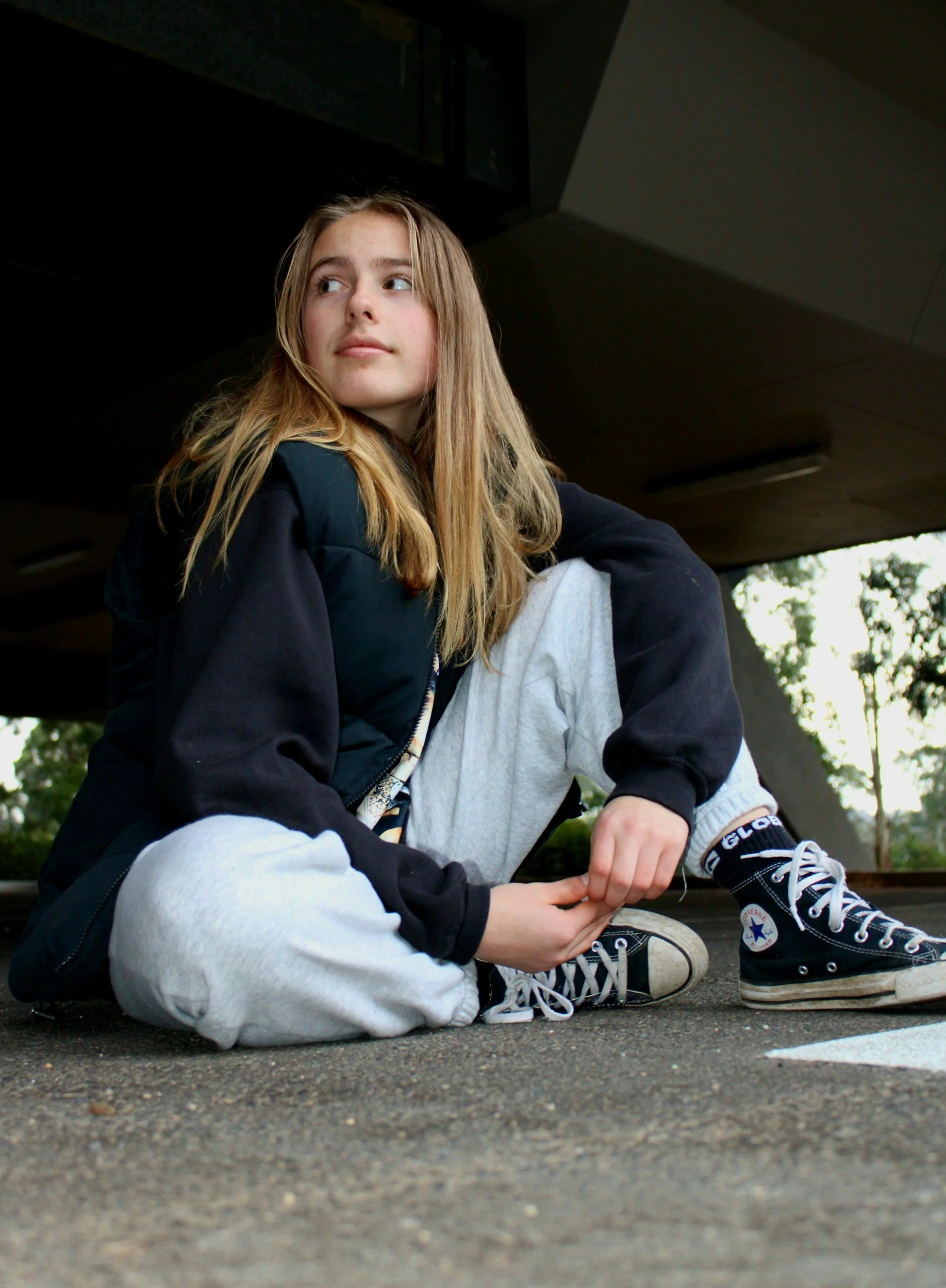 Teen girl sitting and staring off camera