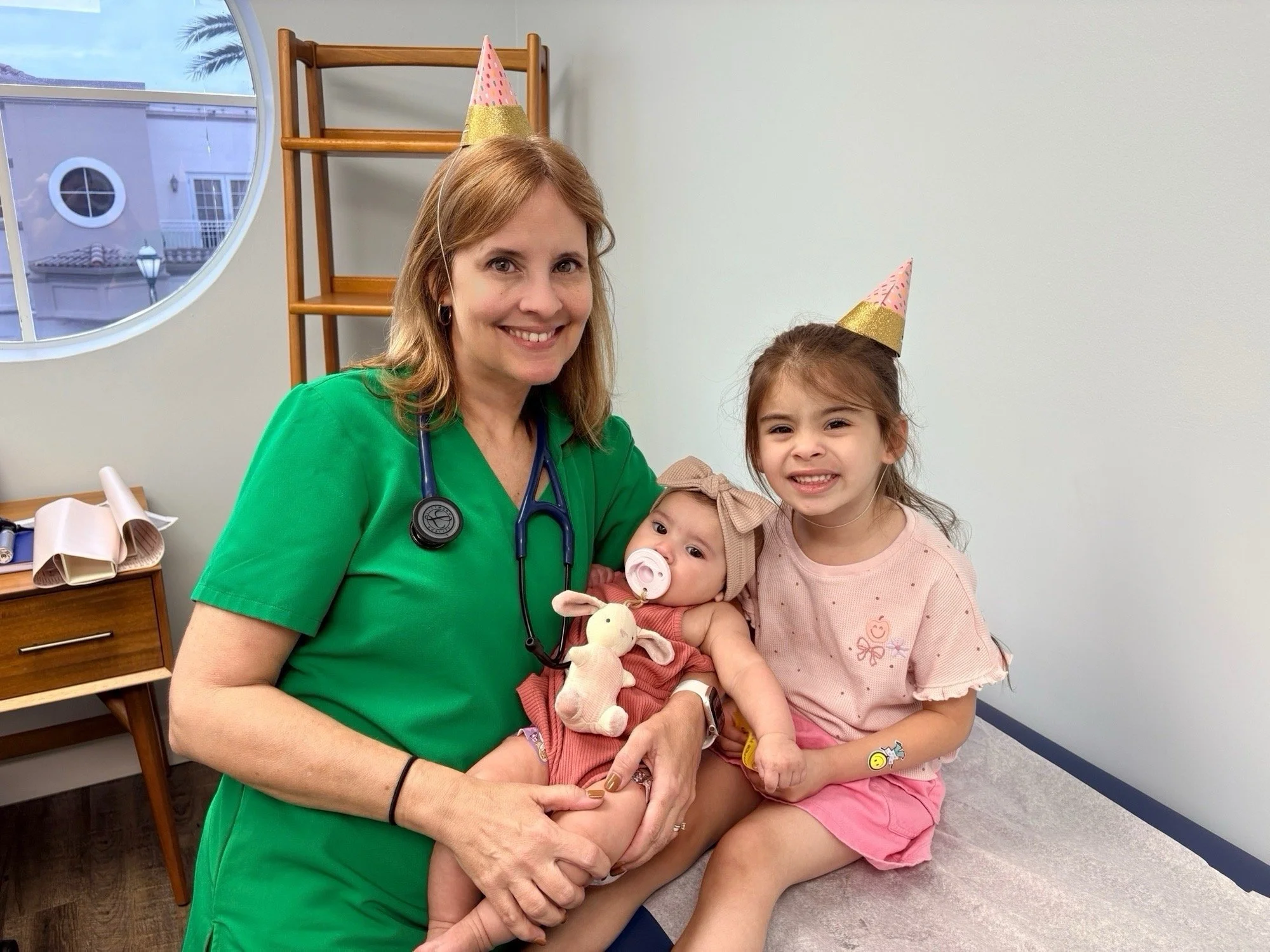 Dr. Lourdes Travieso with baby and girl