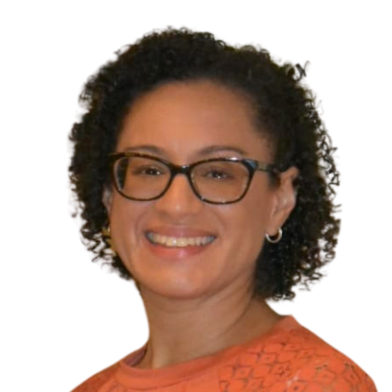 Portrait of a woman with shoulder-length blonde hair, smiling, wearing a white jacket over a black top, against a plain white background.