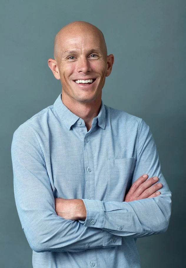 Dr Miles Upfold, chiropractor at Up! Chiropractic Leederville, smiling in a light blue shirt