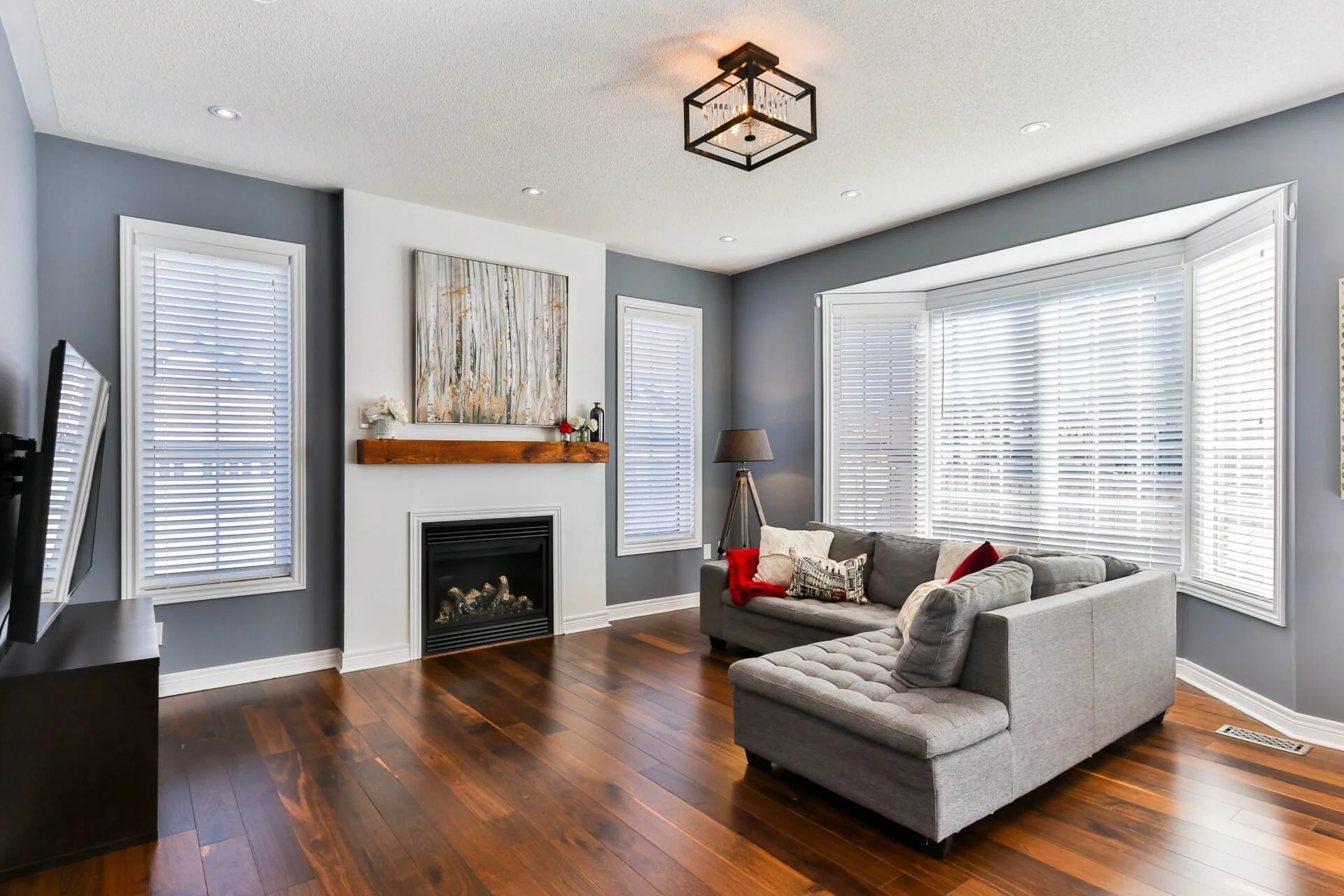Living room with custom plantation shutters installed by NuView