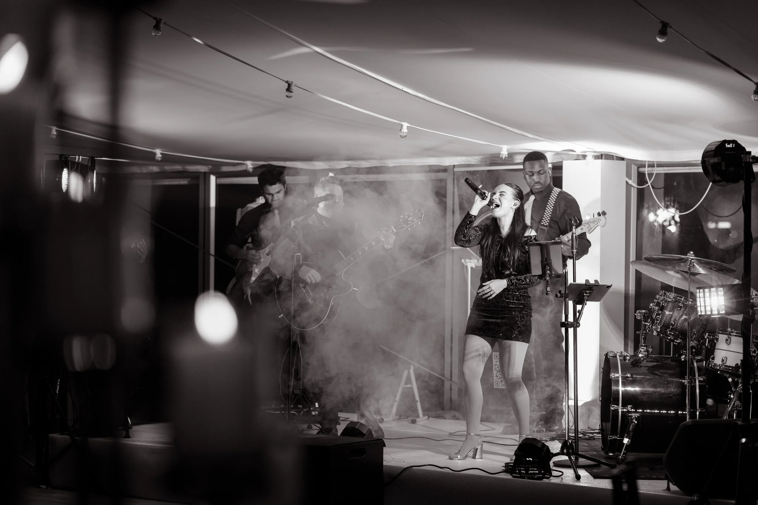 Jemini Band live performance – full 10-piece band with brass, dynamic stage lighting, and soulful vocalists entertaining event guests