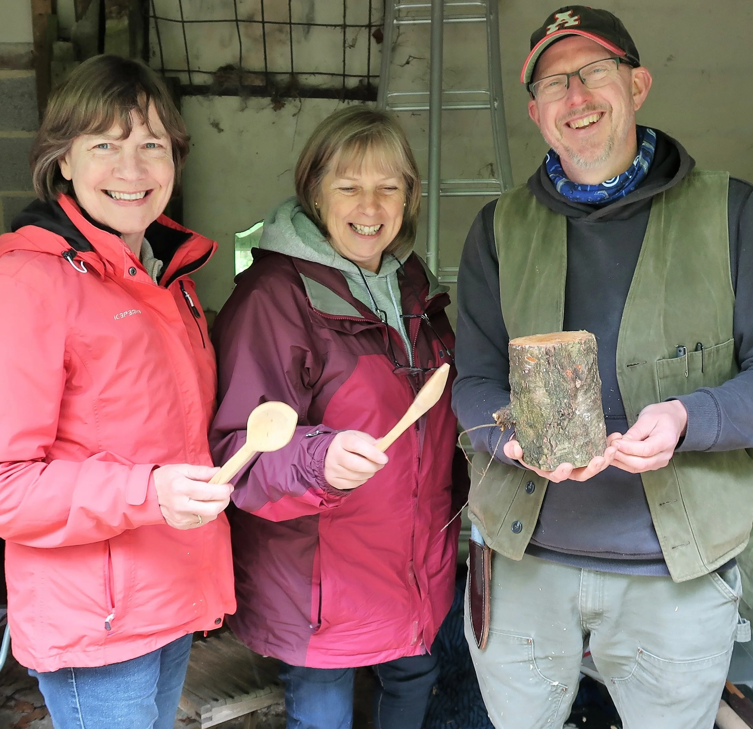 Proud students holding their first spoons, with Mike Craig.JPG