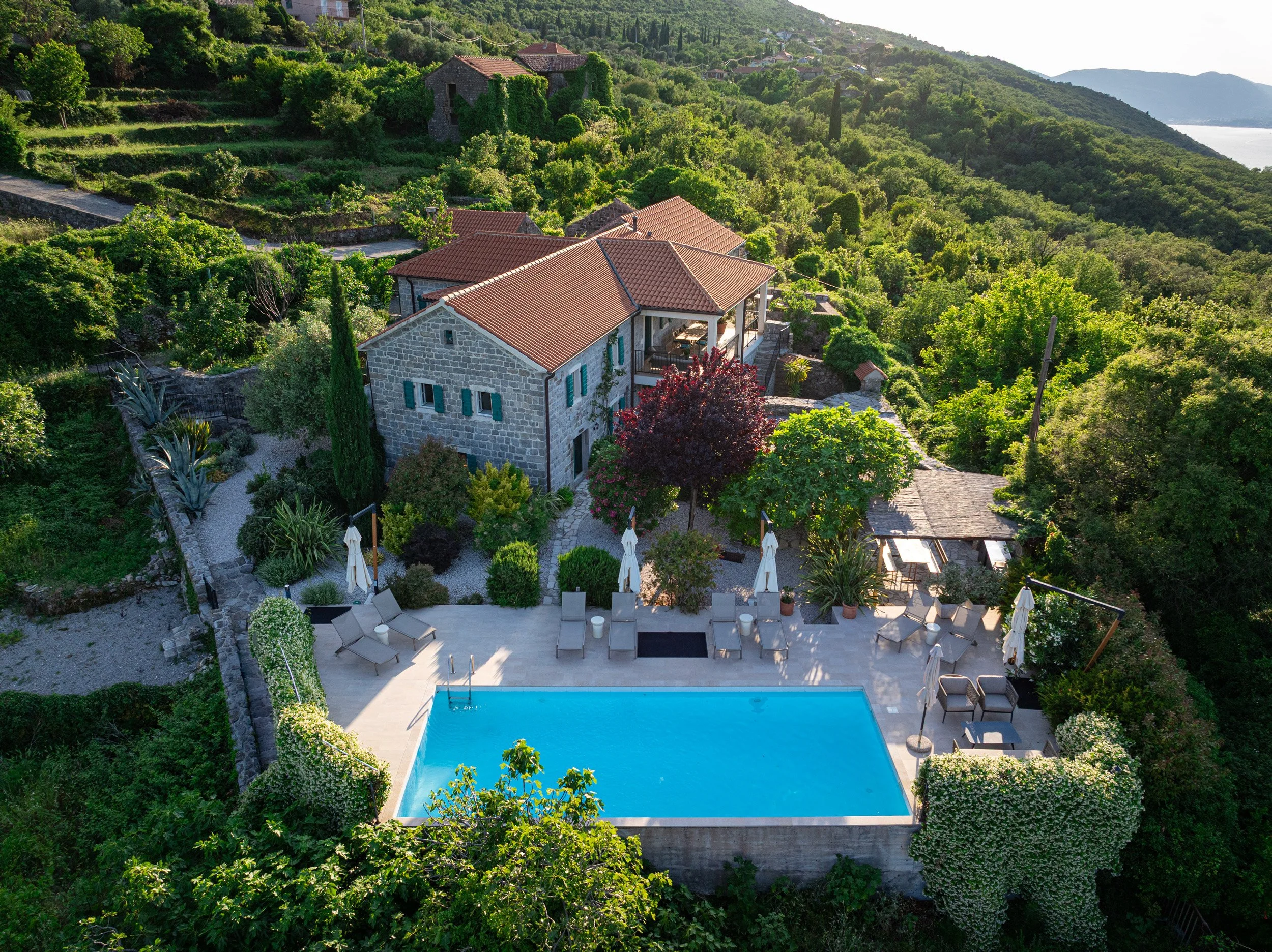 Aerial image of swimming pool and stone villa