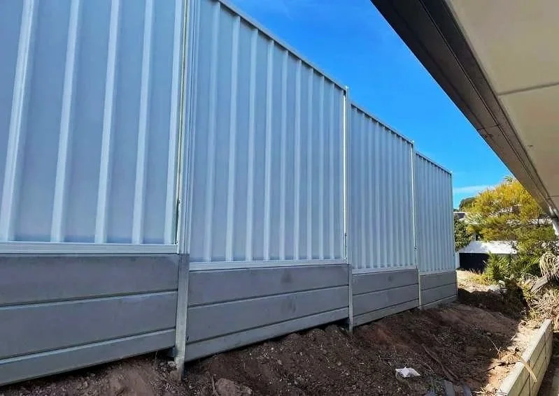 white fencing on retaining wall in property