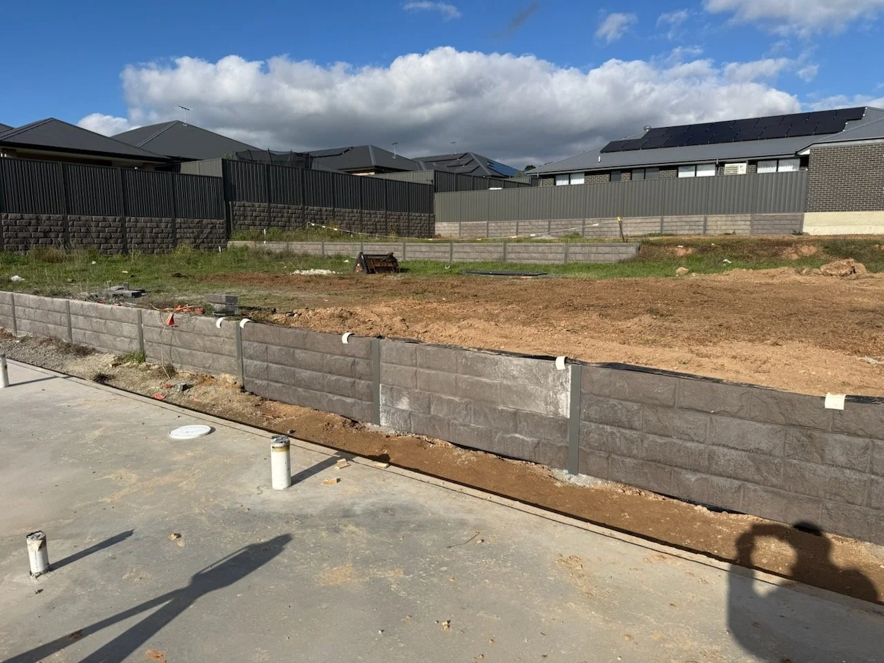 grey fencing on retaining walls in large property