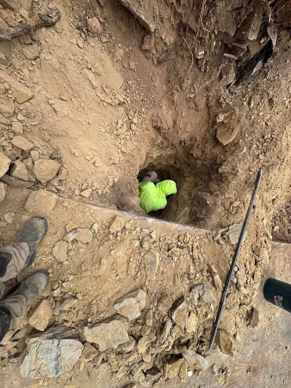 drill to dig the footings and also with manual digging to remove large rocks and prepare the footing area