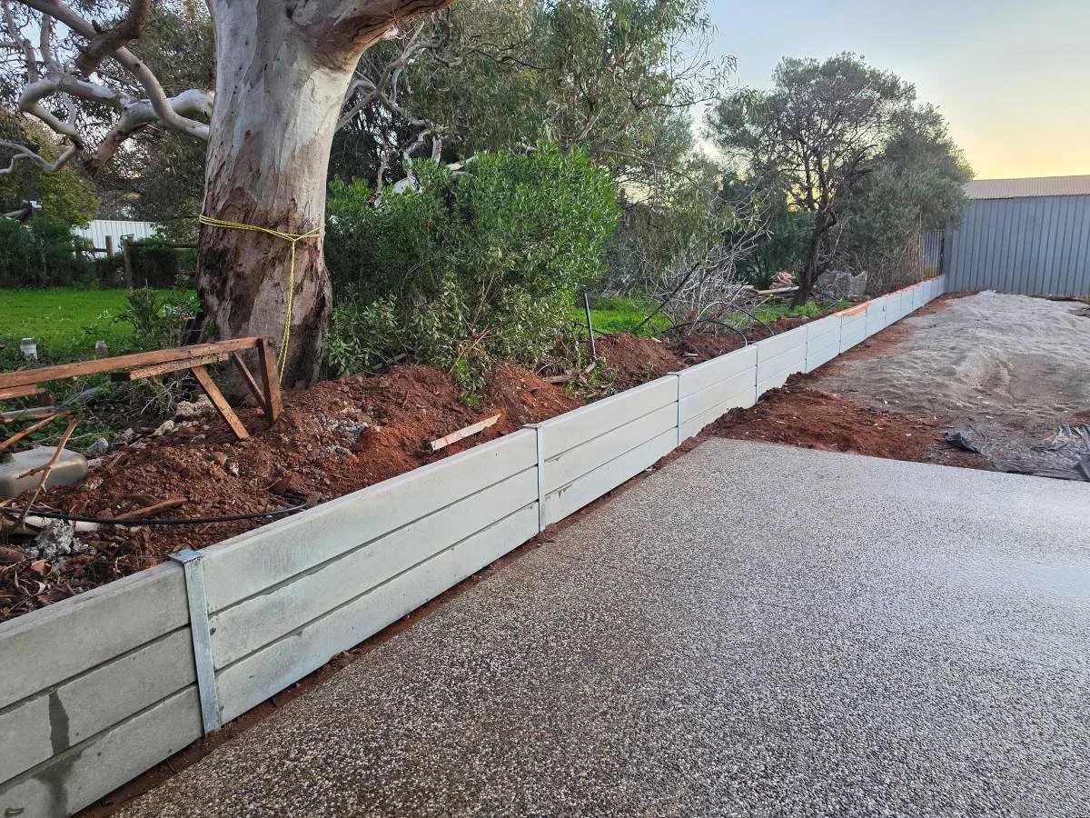 Retaining walls with plain grey concrete sleepers