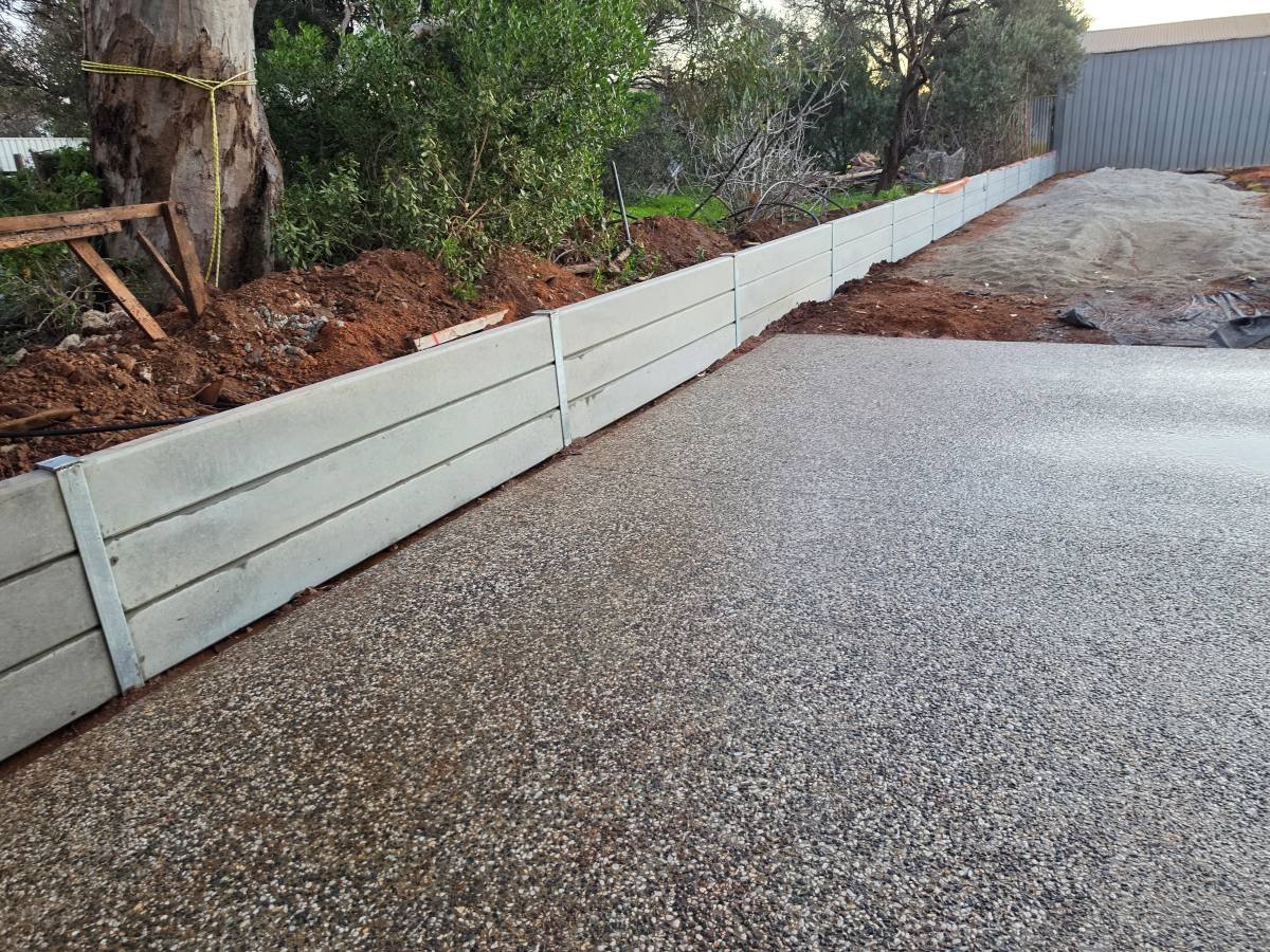 Retaining walls with plain grey concrete sleepers in Sellicks Beach