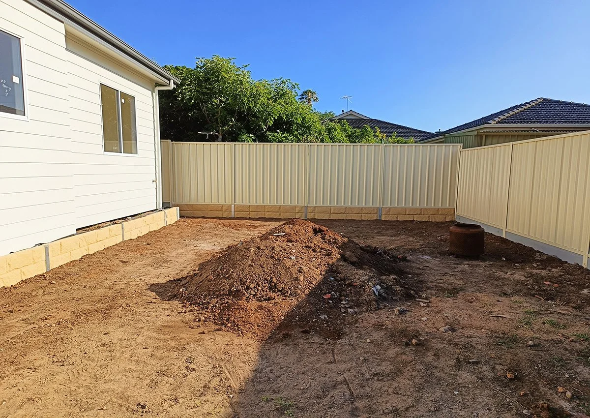 Retaining Wall with Cove sleepers plus Good Neighbour fence on Top and garden Beds around