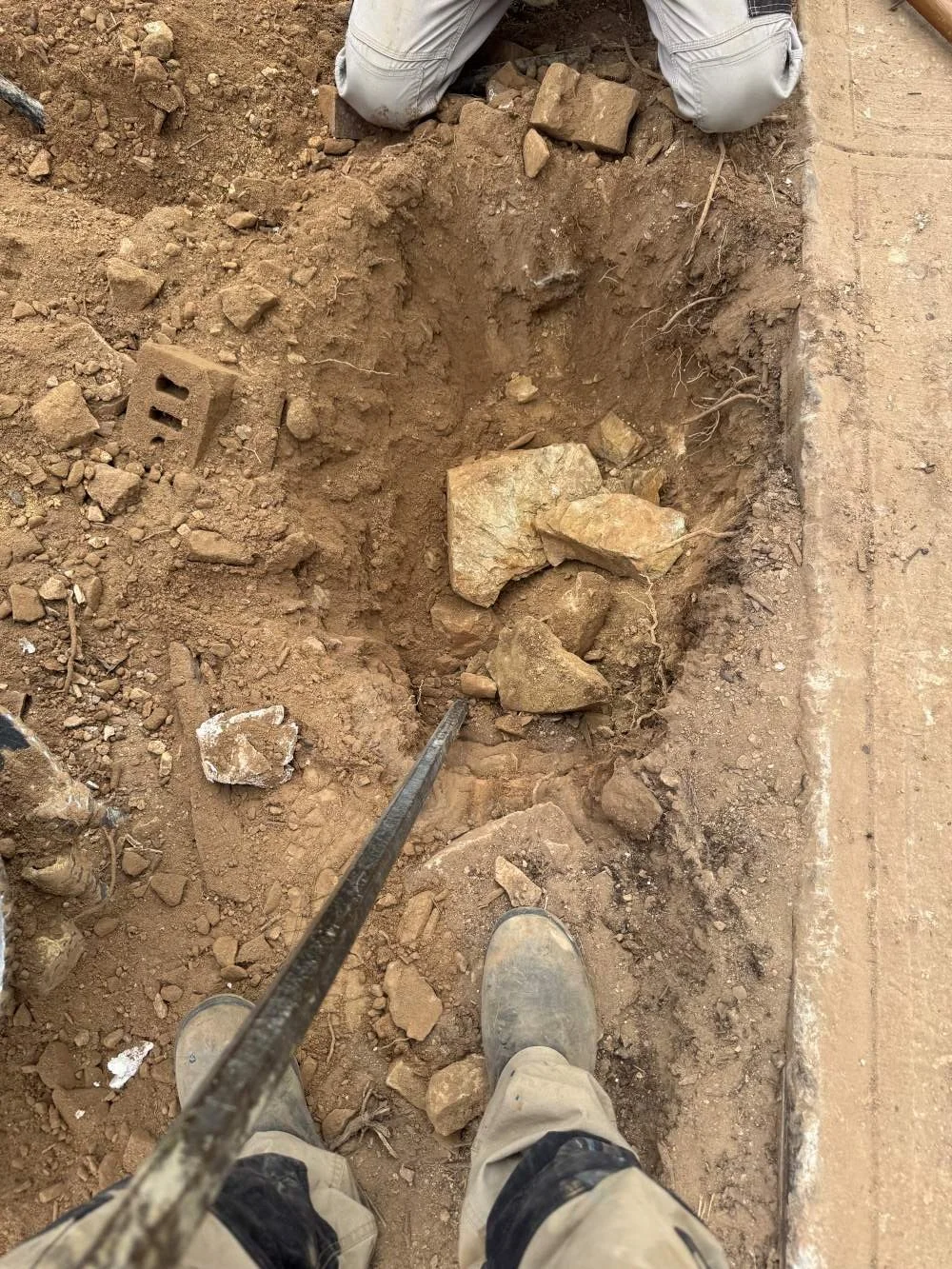 drill to dig the footings and also with manual digging to remove large rocks and prepare the footing area