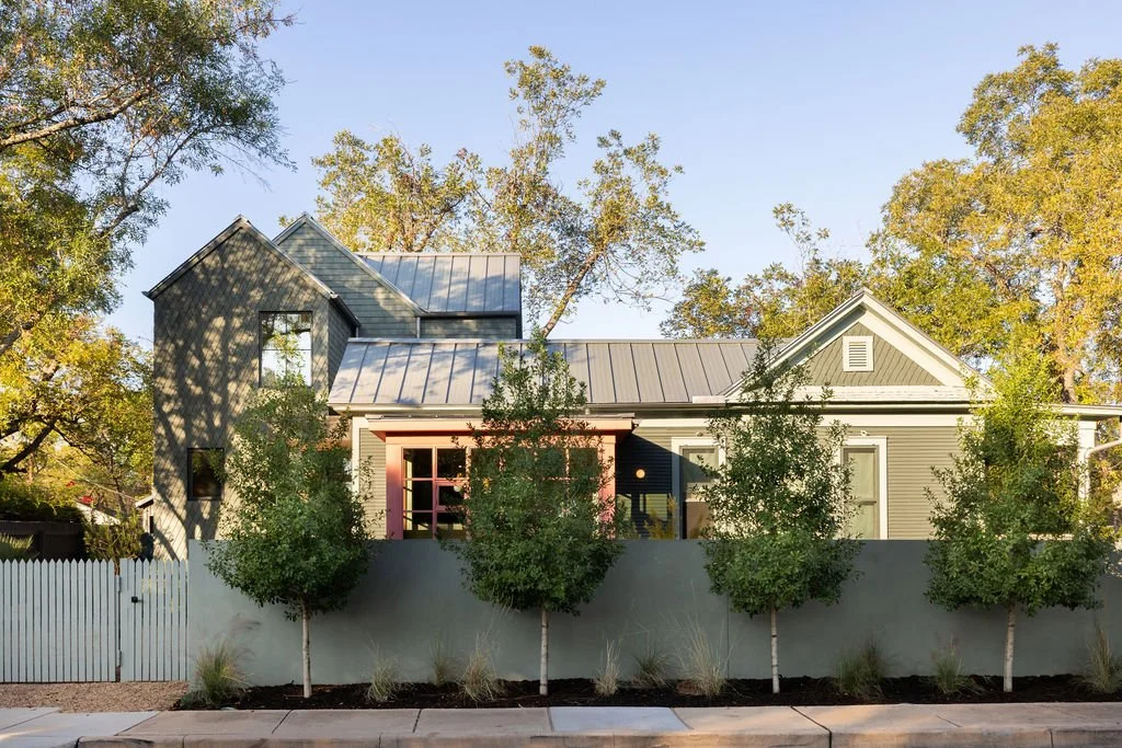 A historic Folk Victorian home with a contemporary addition, with a sunroom jewel box addition.