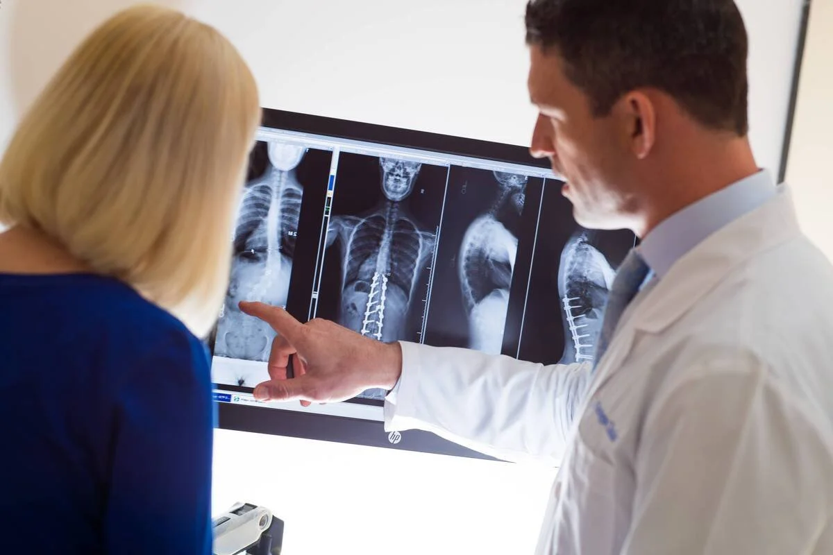 MISH spine specialist reviewing a patient's spinal imaging