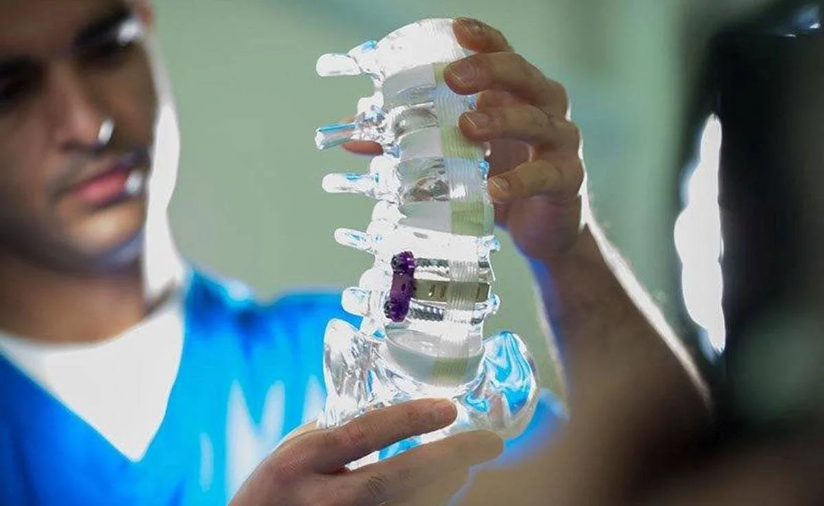 Spine specialist explaining treatment using an anatomical model