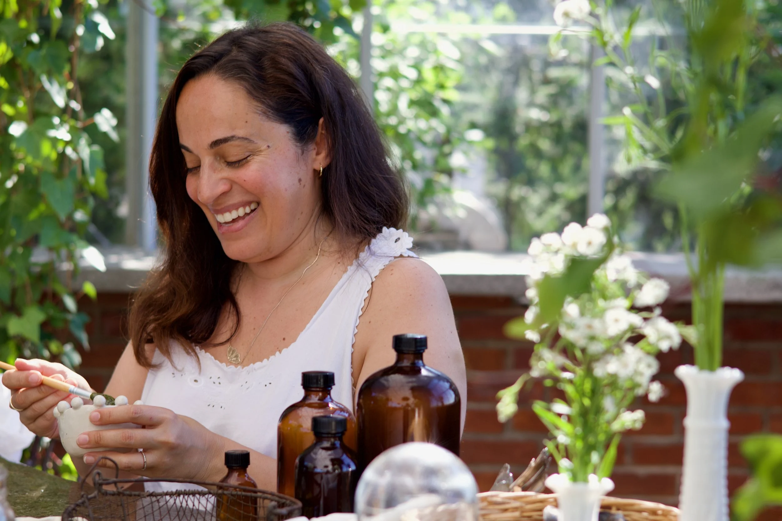 Stacey from Simply Flourished smiling as she mixes her mask.