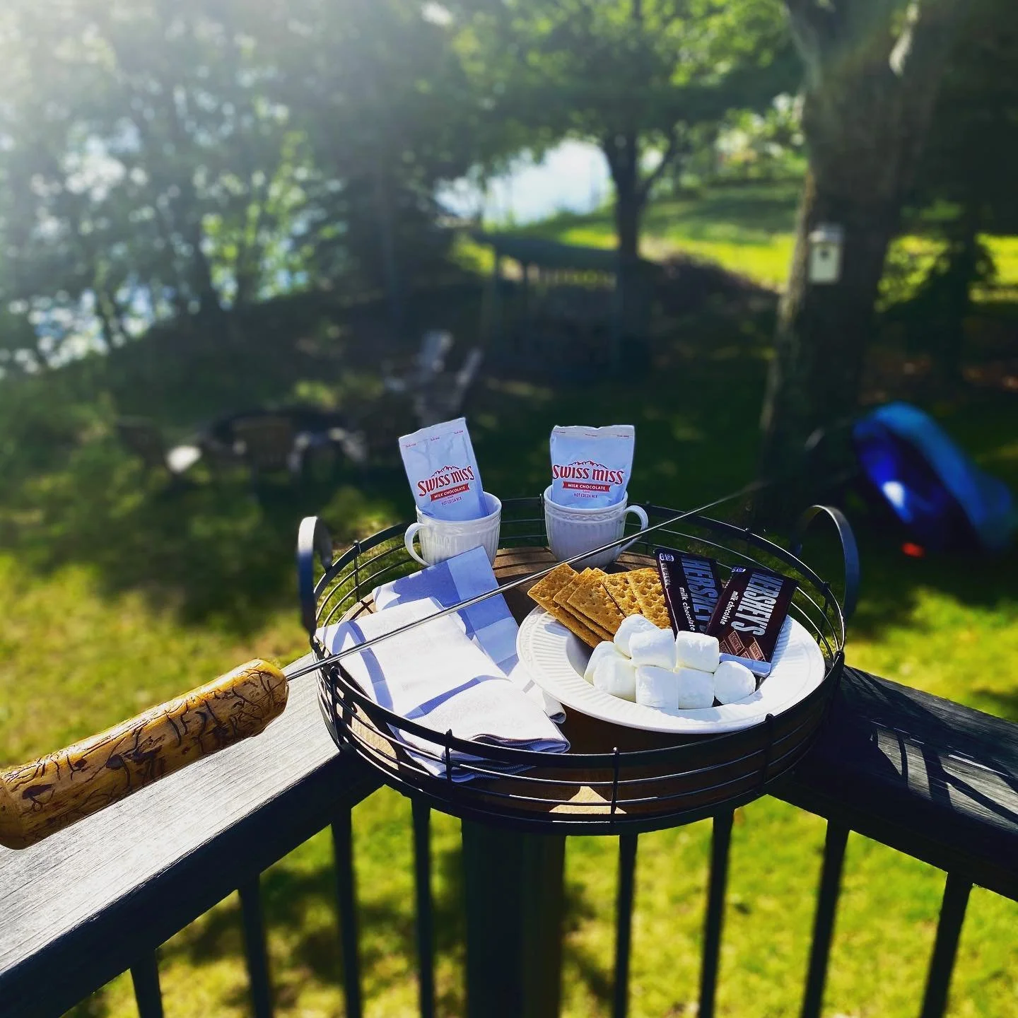 Basket with s’mores ingredients on deck overlooking Island Lake.