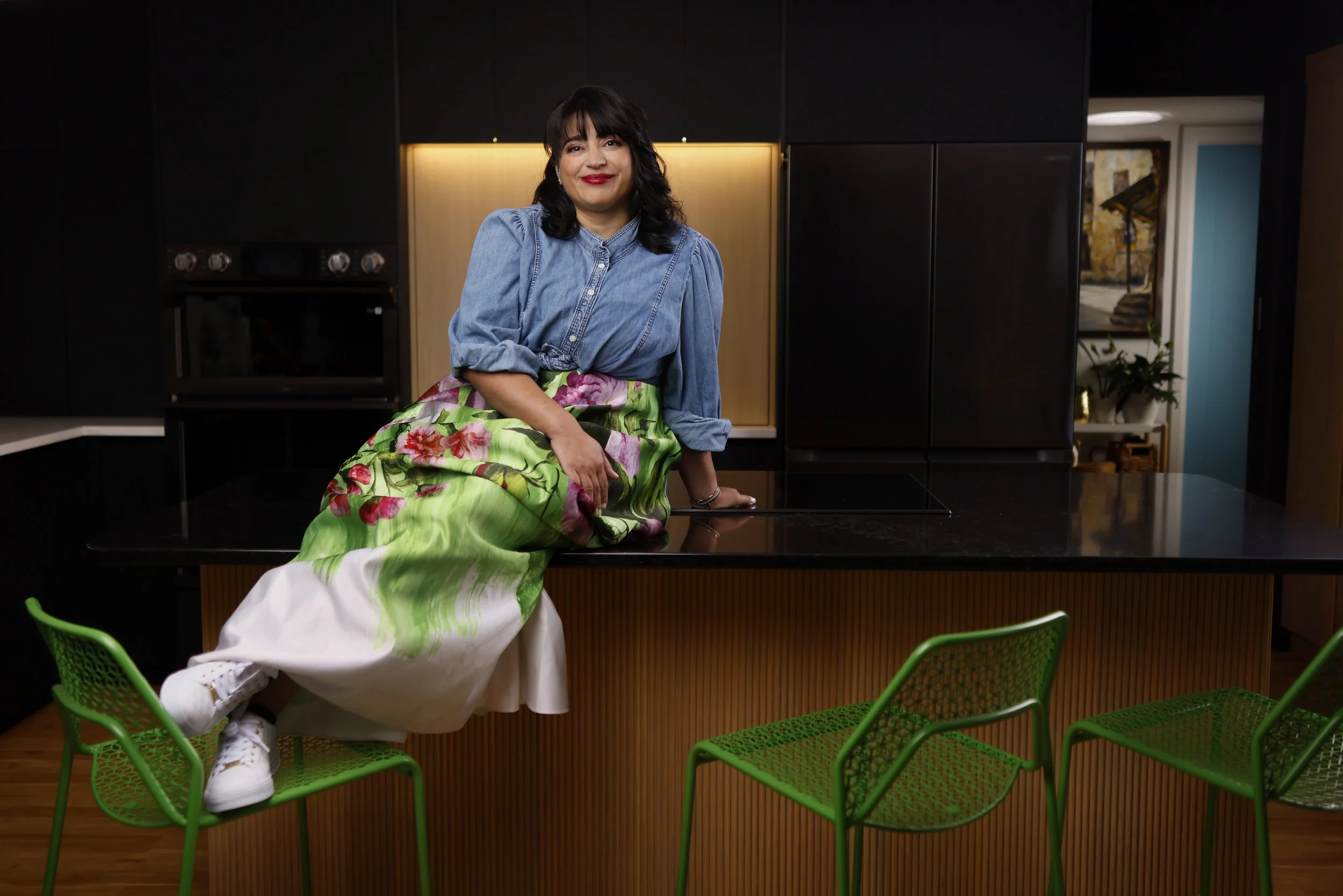 Leilla is sitting on a counter in a kitchen with a black background.