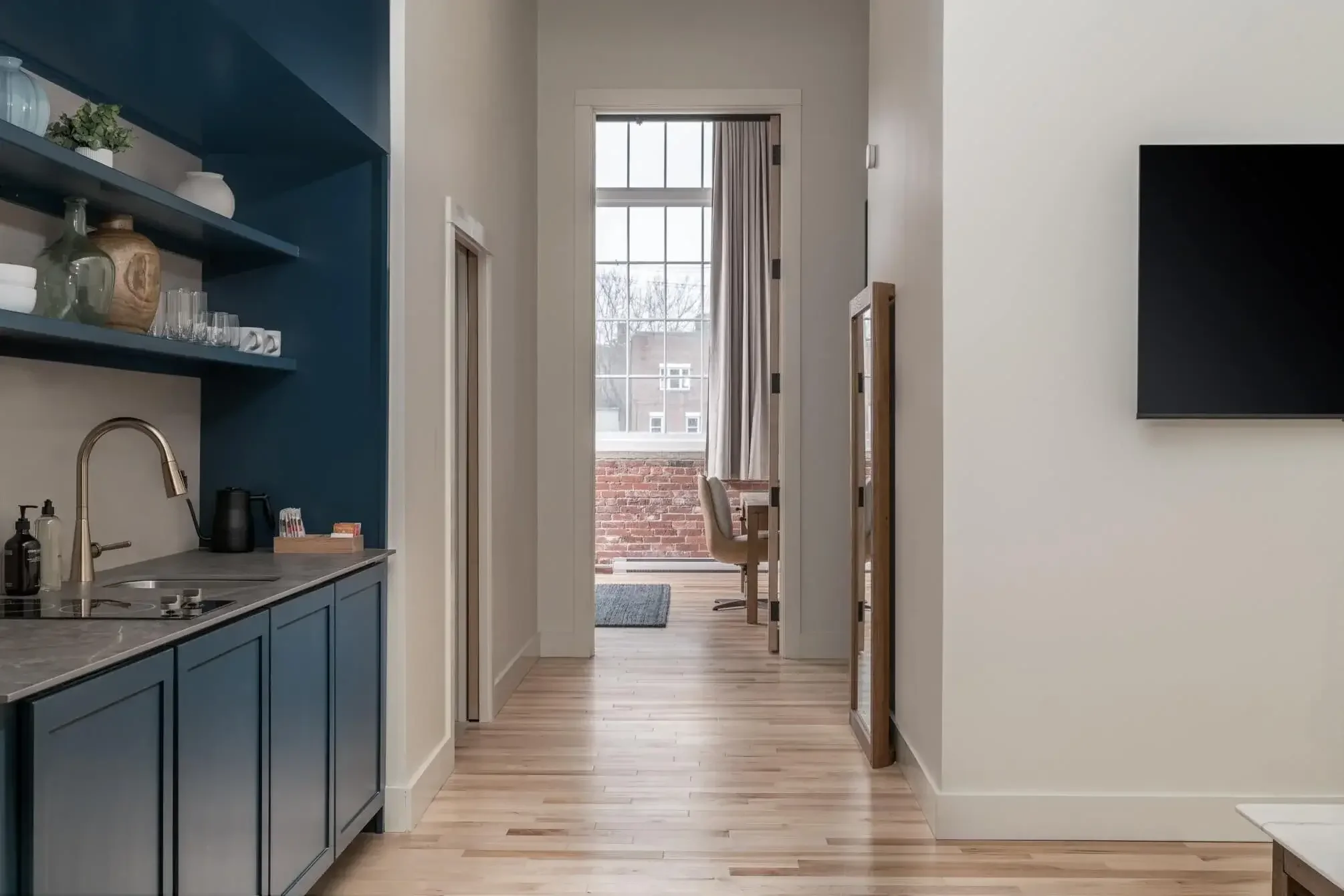 Kitchenette and living area in a  Deluxe King room at The Skowhegan