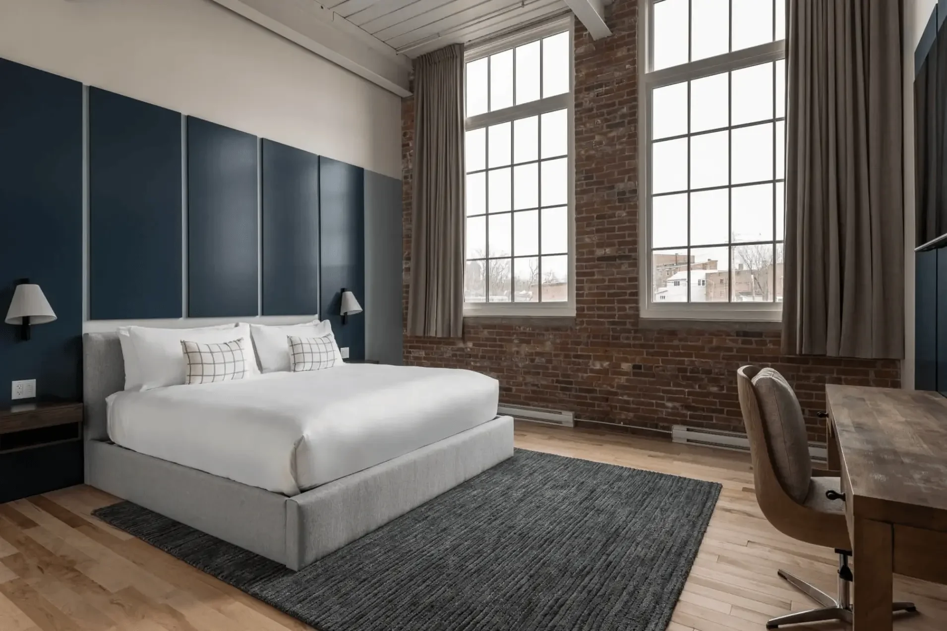 Boutique hotel room with oversized windows and Kennebec River view at The Skowhegan