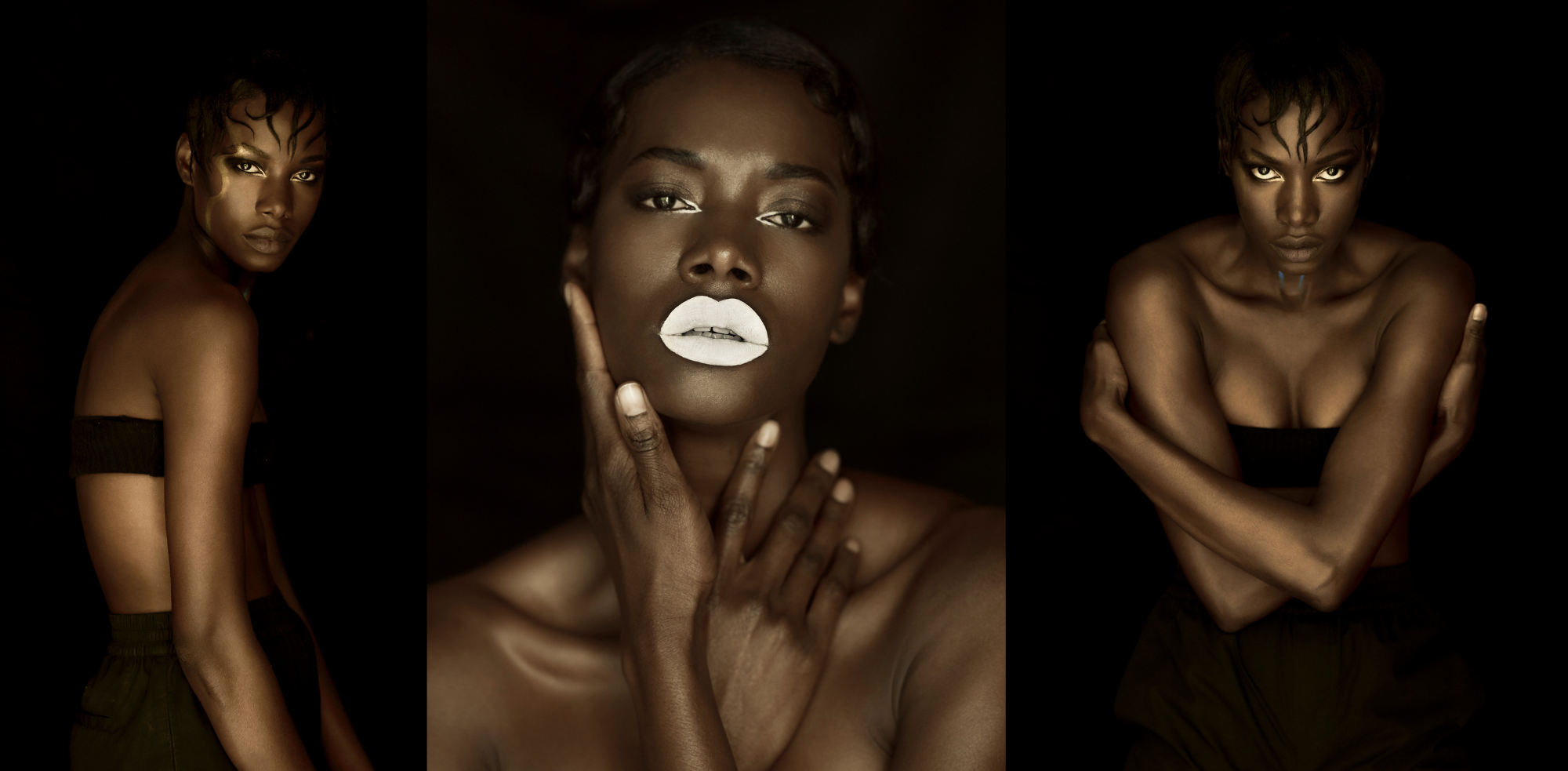 An African American woman with dark skin sets against a black background with black clothing allowing her gold and white makeup to pop. Photography by Nathanael Filbert, beauty photographer.