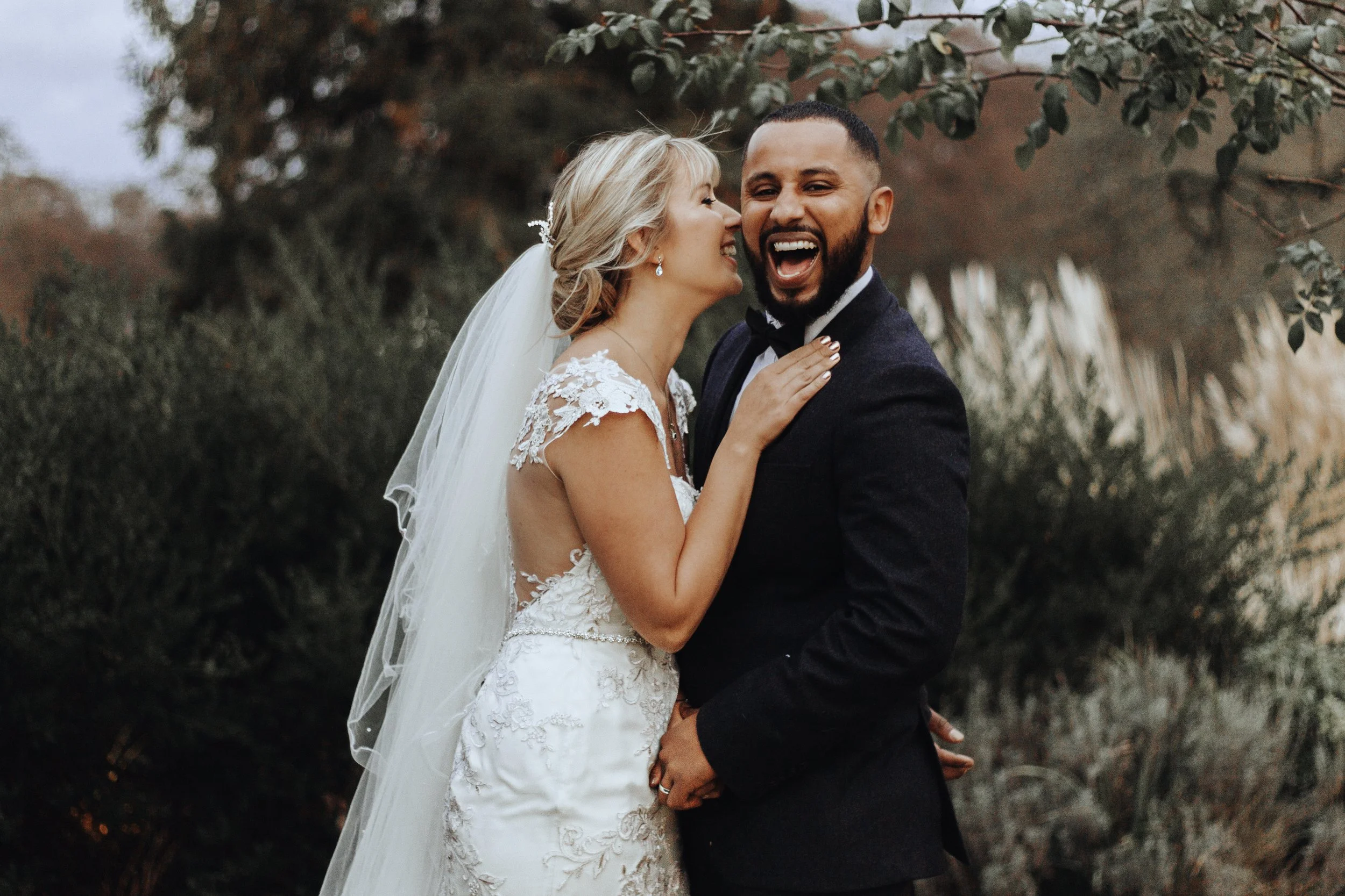 Bride and groom laughing together during their wedding