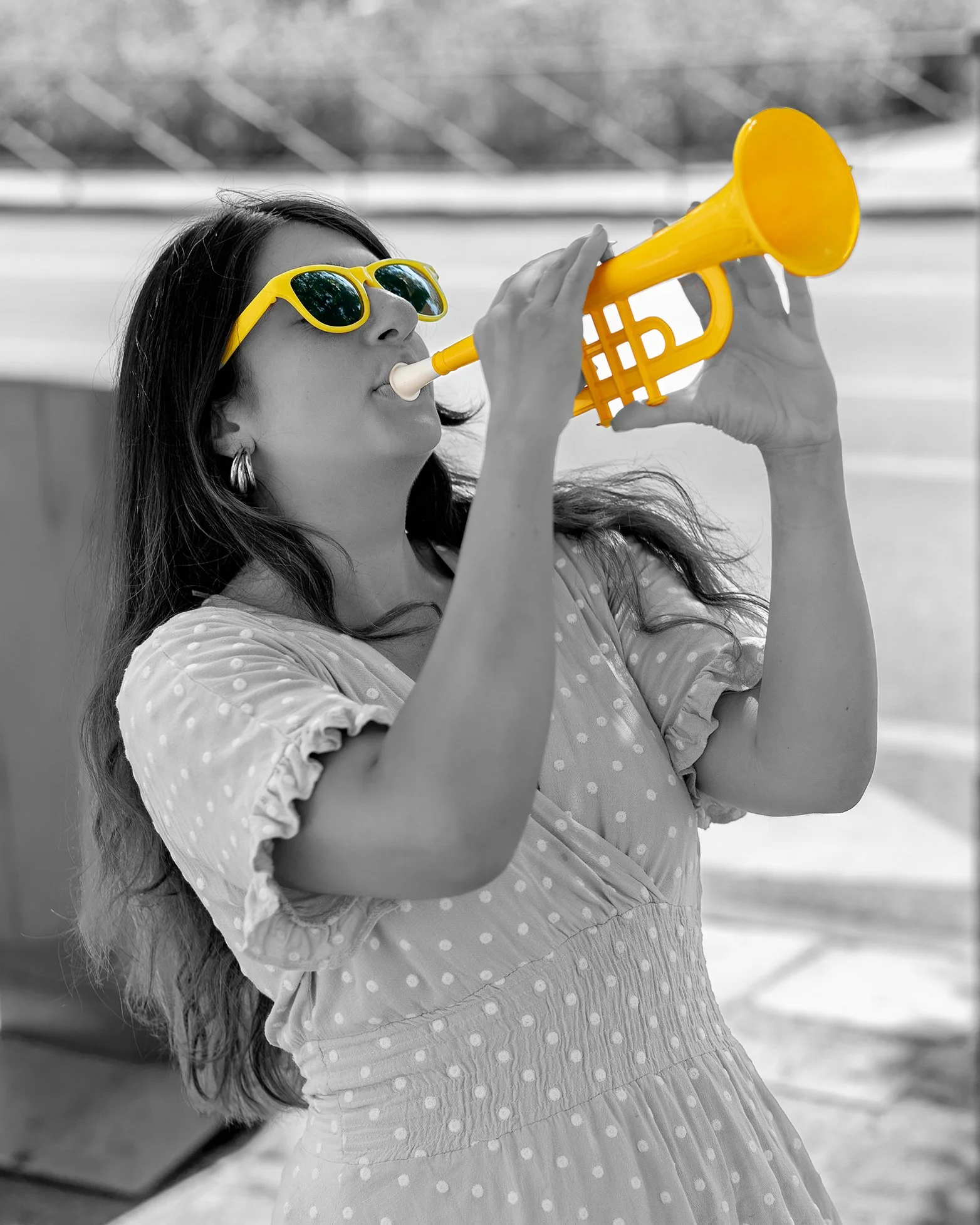 Rawan Ajami, Project Manager at Yussef Co., blowing a yellow trumpet to announce a new project enquiry.