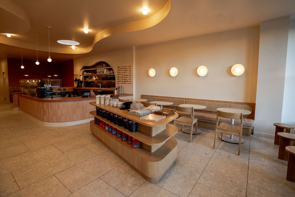 aesthetic coffee shop curved ceiling soffit, tile counter, mirror behind bar, desert color palette