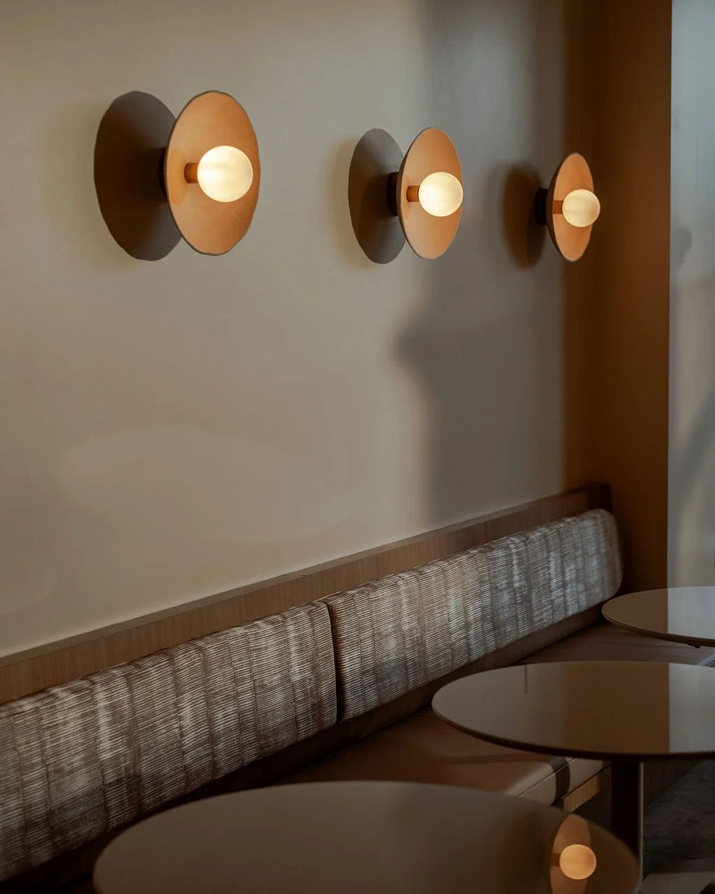 wall sconces and built-in banquette seating