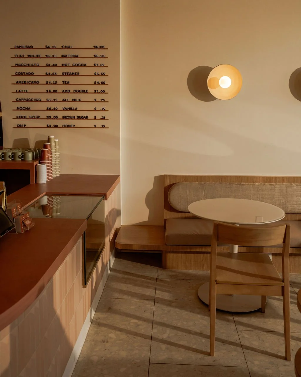 coffee menu on wall built in banquette seating modern wall sconce