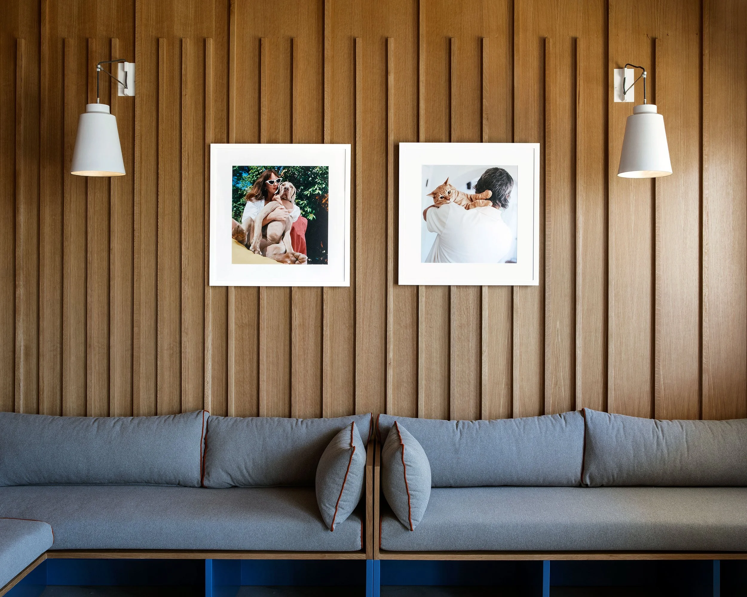 Close up picture of lounging couches and portraits on walls 