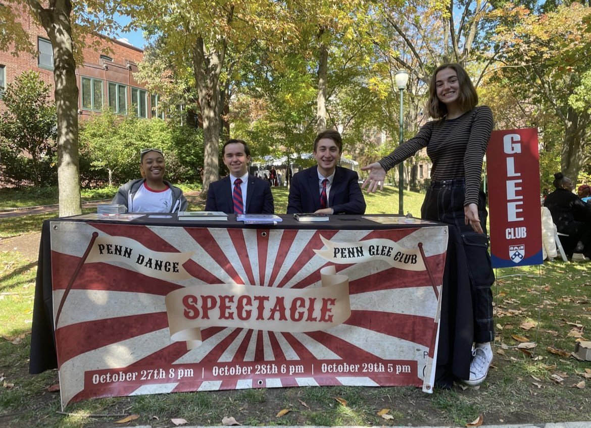 Members of the Penn Glee Club advertising its 2022 Fall Show on Locust Walk.