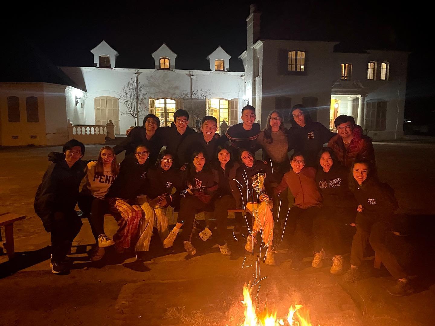 Members of the Glee Club huddled around a bonfire in Santa Cruz, Chile.