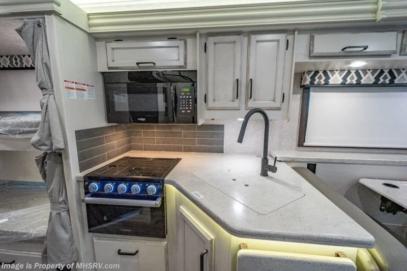 Kitchen with sink, microwave, and oven