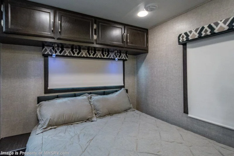 Bedroom with queen bed and cabinets