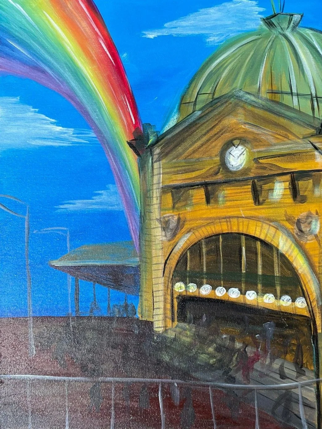 Painting of flinders street station with a rainbow. It features the clock facade that lies on the corners of swanston st and flinders street. The skies are blue with passing clouds. There is an implied business across the pavement.