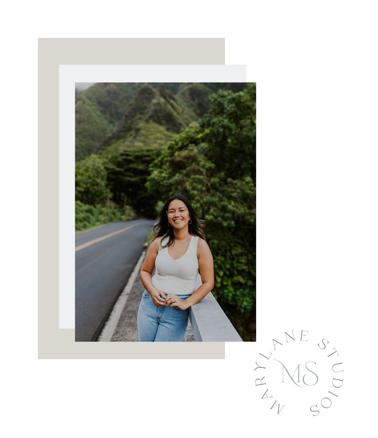 Maui photographer posing along a scenic road surrounded by lush mountains