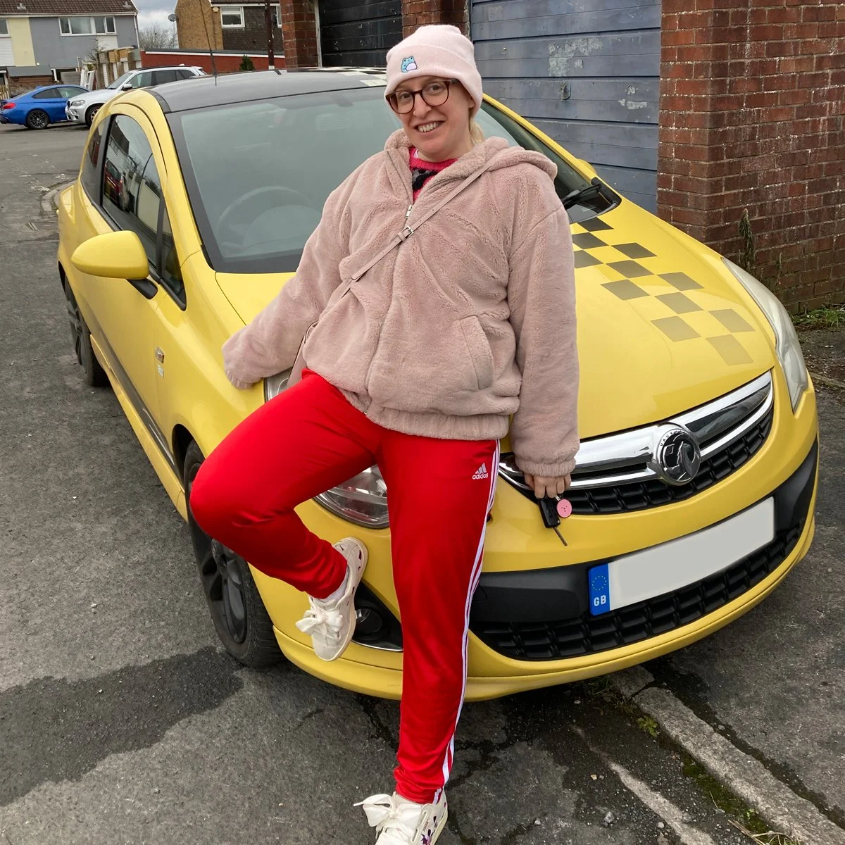 Photo of Louise Yeo in front of yellow car