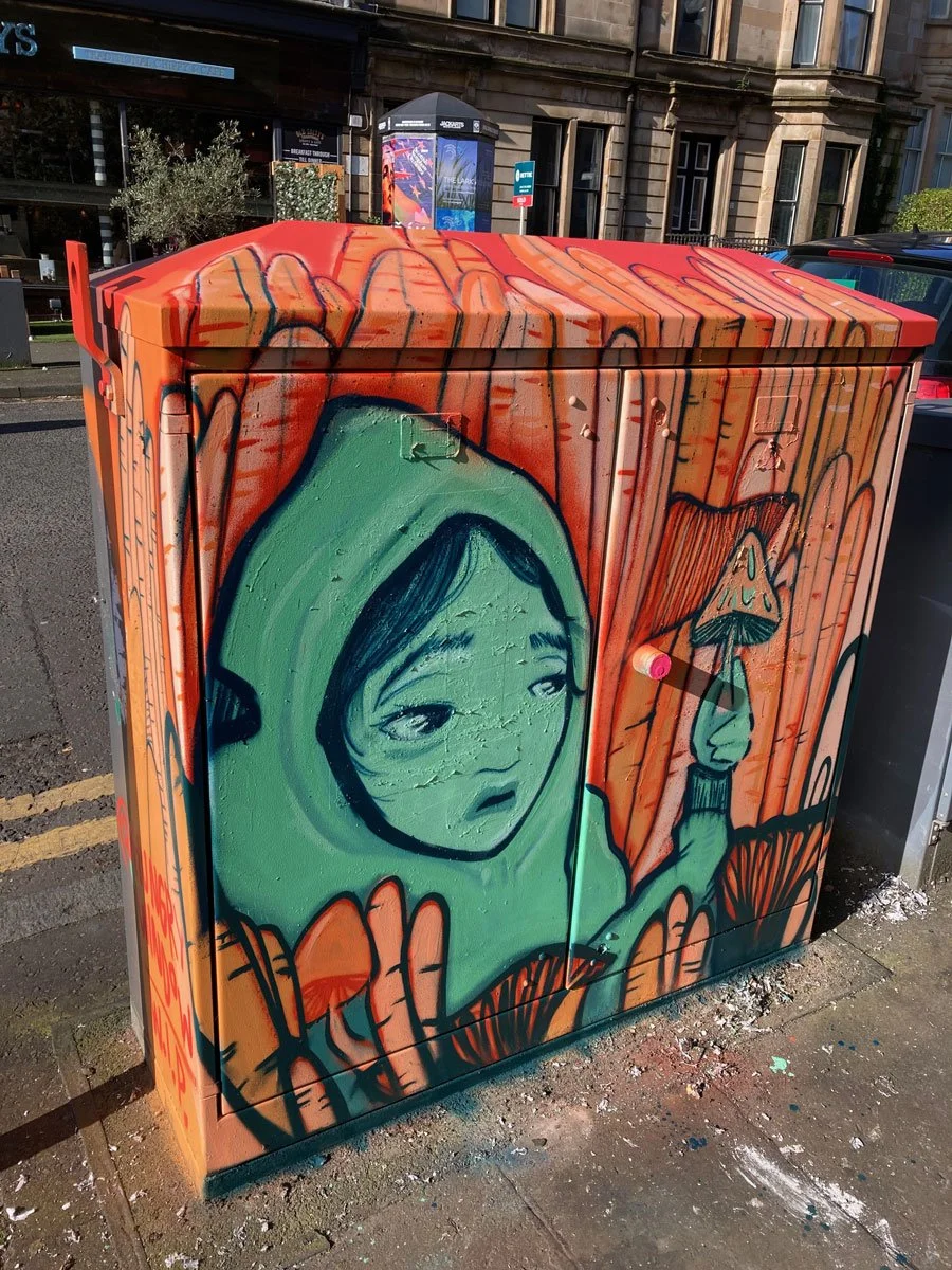 Grafitti of a hooded character and mushroom, glasgow