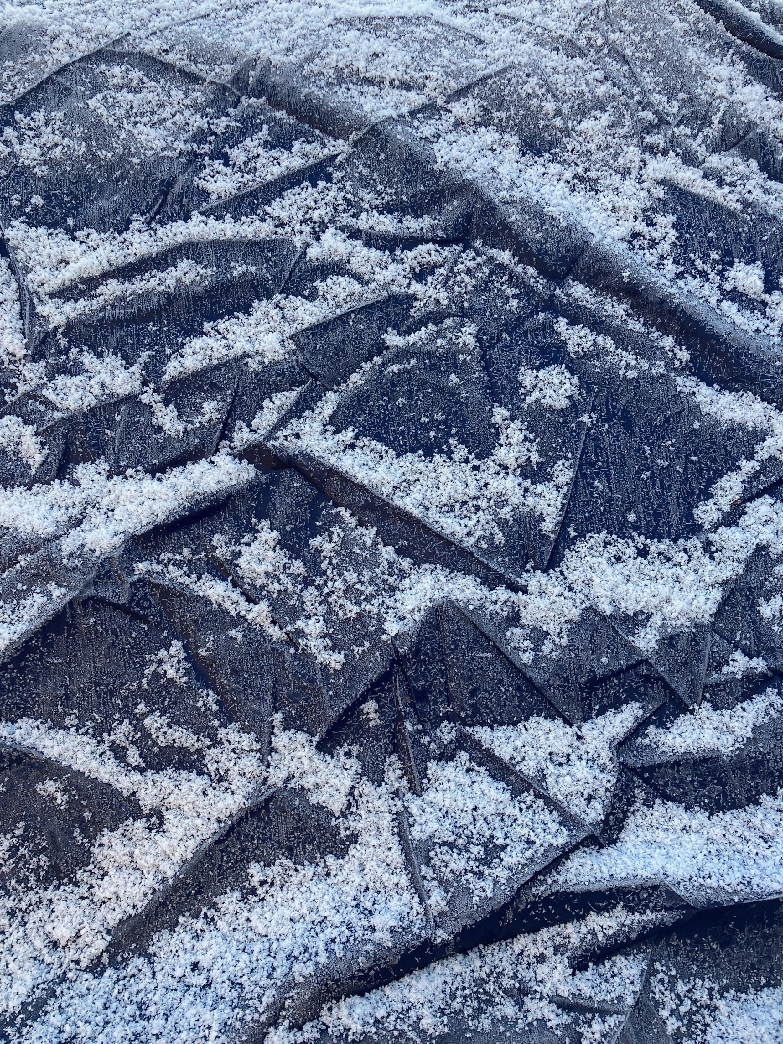Tarp covered in snow that looks like snowy peaks