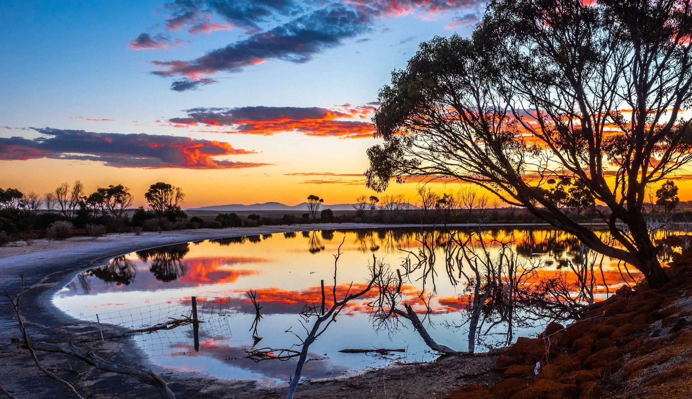 Sunset skies over rolling farmland in the Mount Barker region of Western Australia.