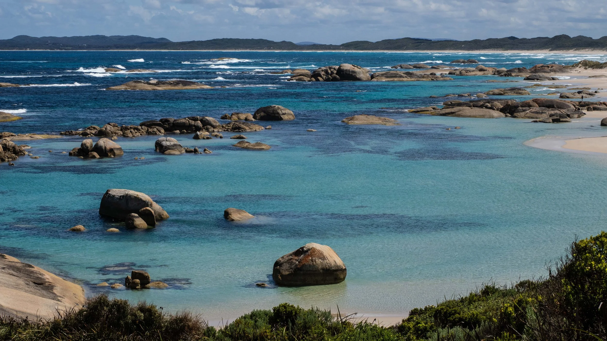 Landscape view of Greens Pool in Denmark WA with turquoise water, granite rocks and white sand beach.