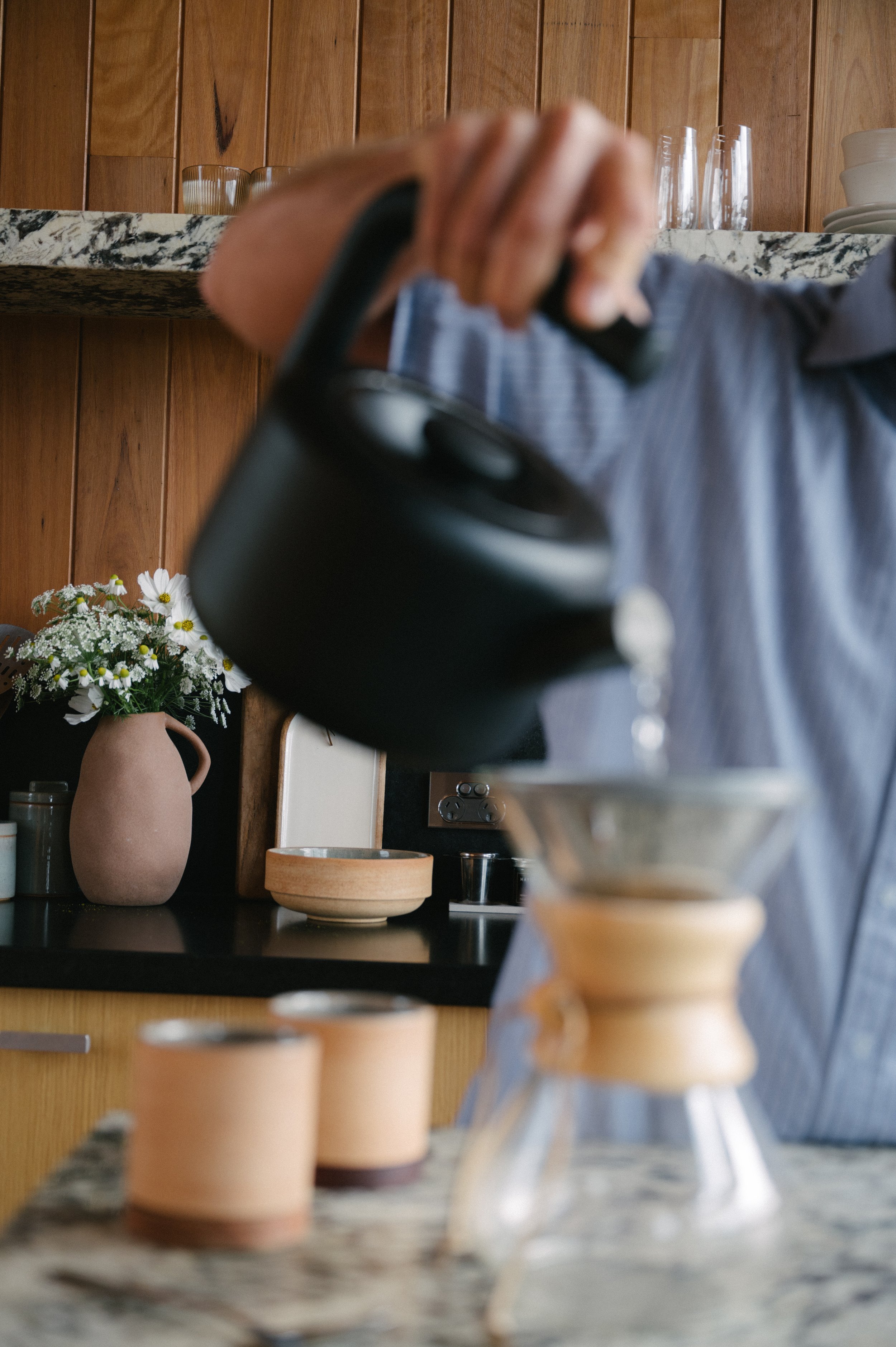 Man pouring a fresh cup of coffee during a morning in Denmark WA