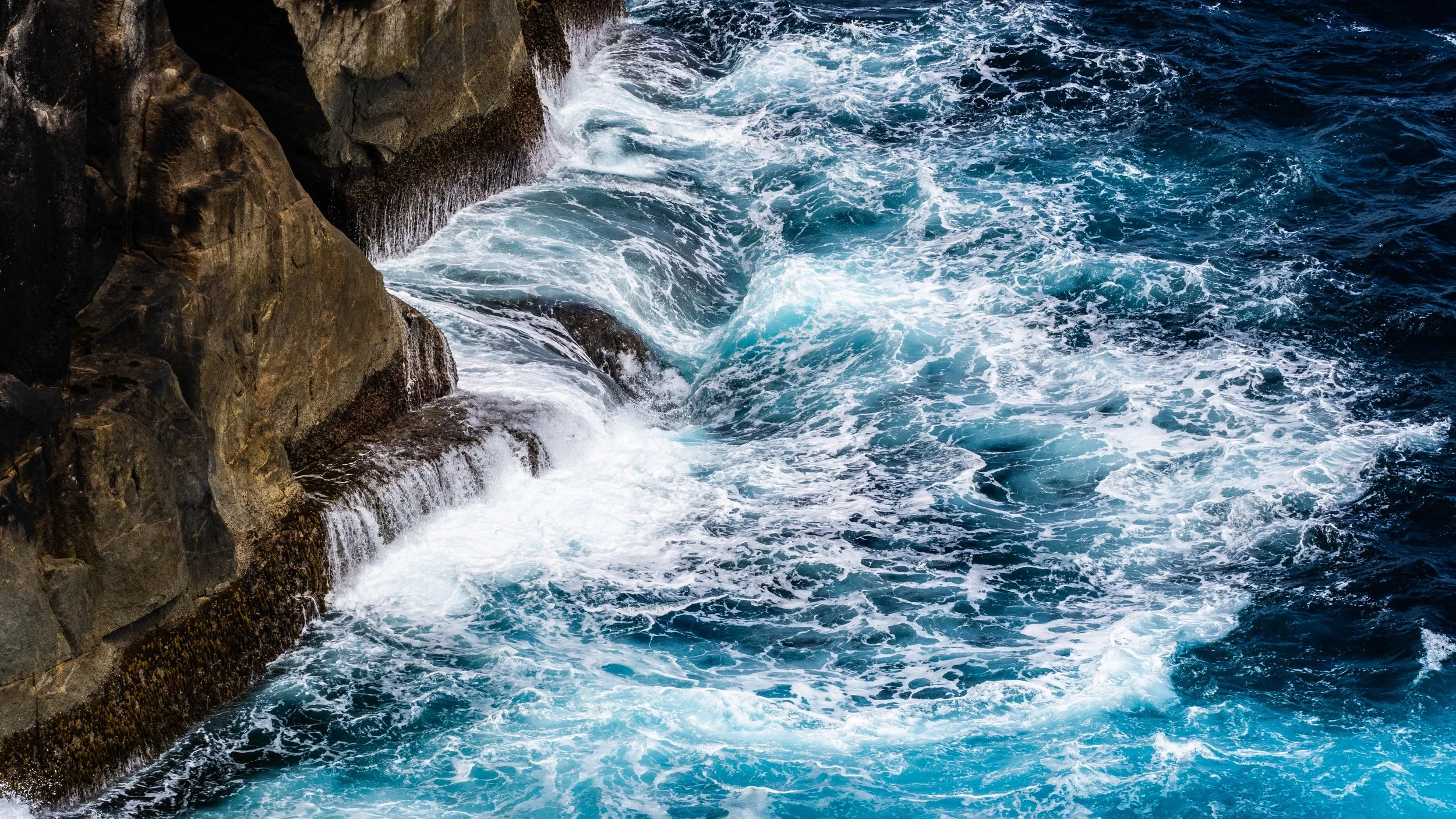 Waves crashing against granite cliffs at The Gap in Torndirrup National Park near Albany WA.