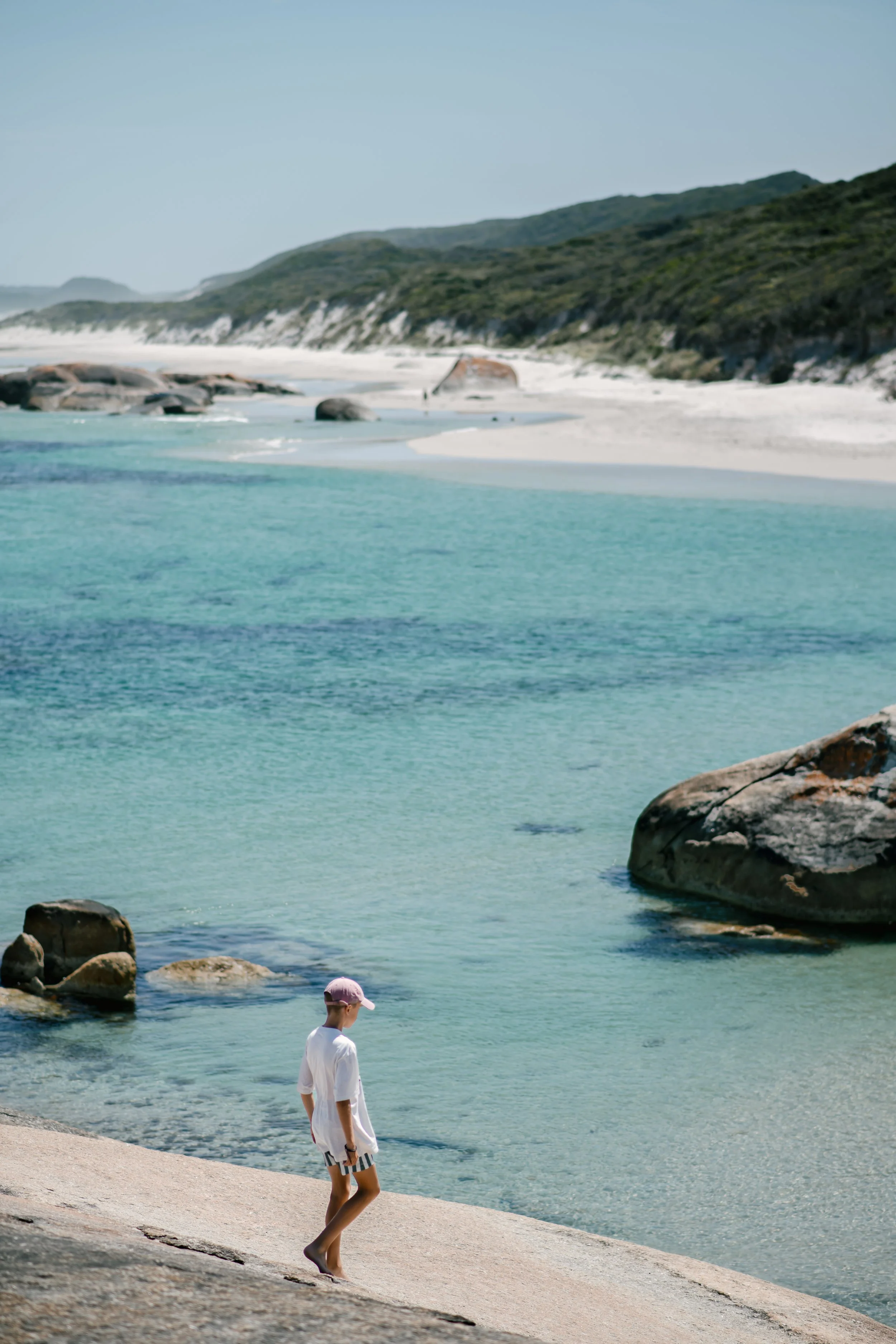 A young boy exploring the granite rocks at Greens Pool in William Bay National Park, near Denmark, Western Australia.