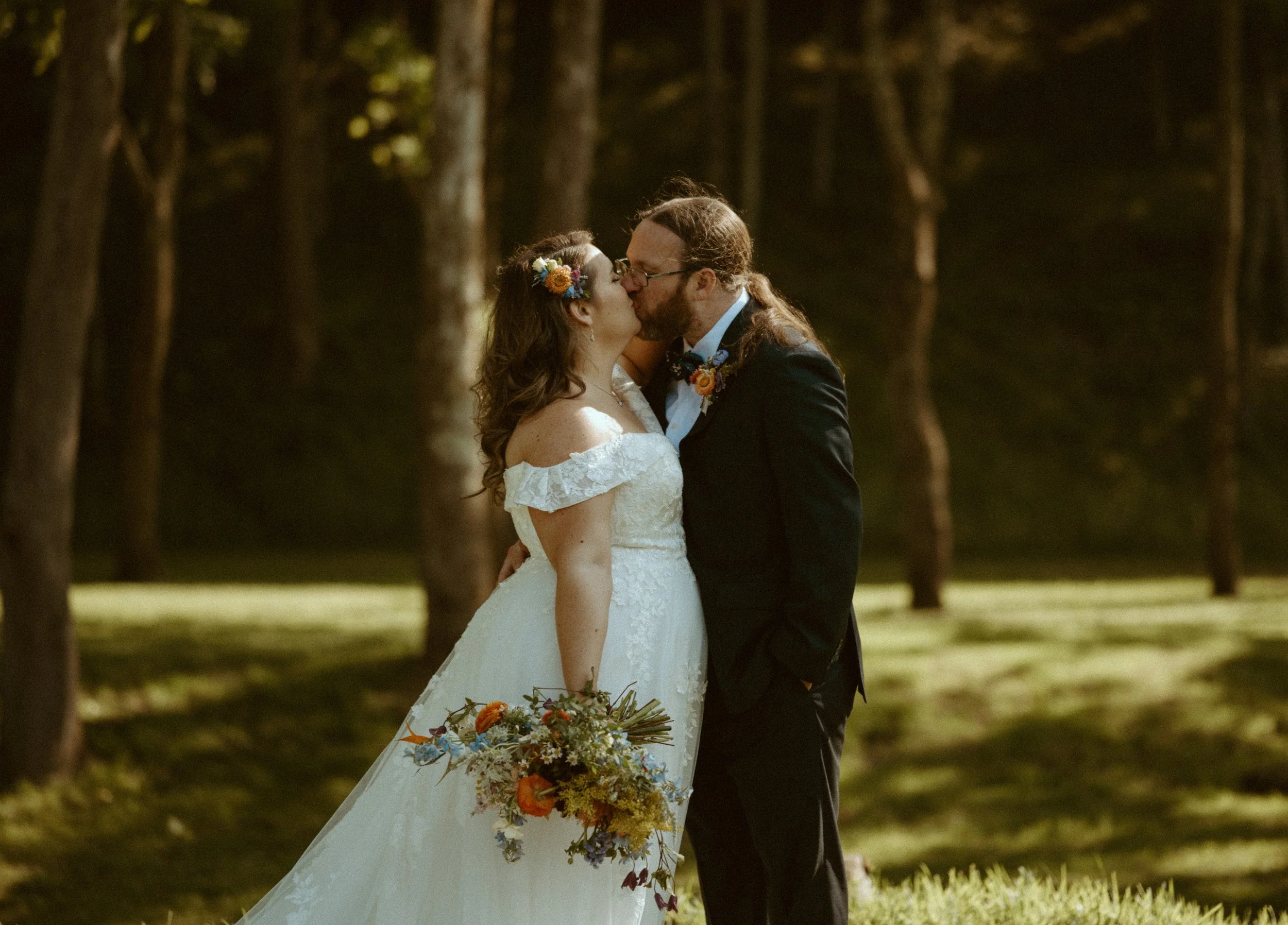 Bride and Groom in the woods Firerock Station - Valis, North Carolina bride holding flower bouquet of wildflowers 