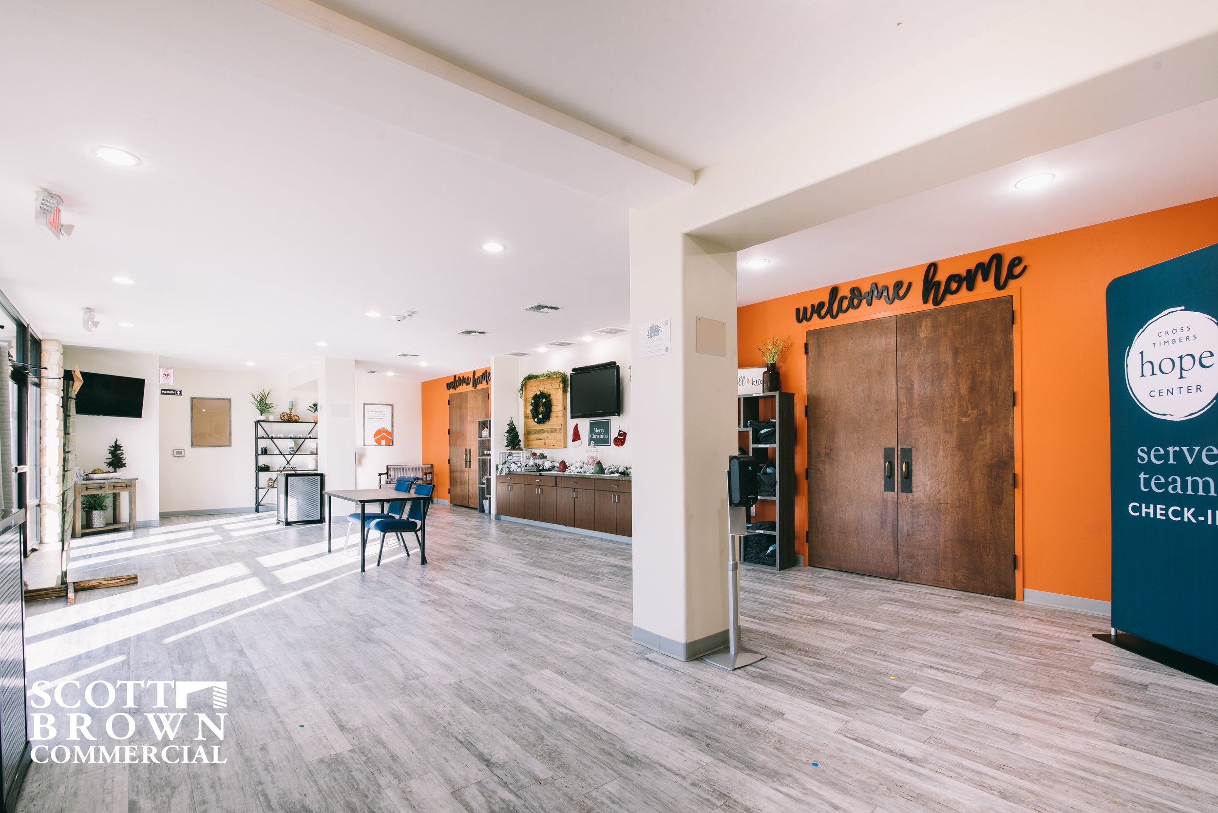  an entry staging area with white walls and orange accents 