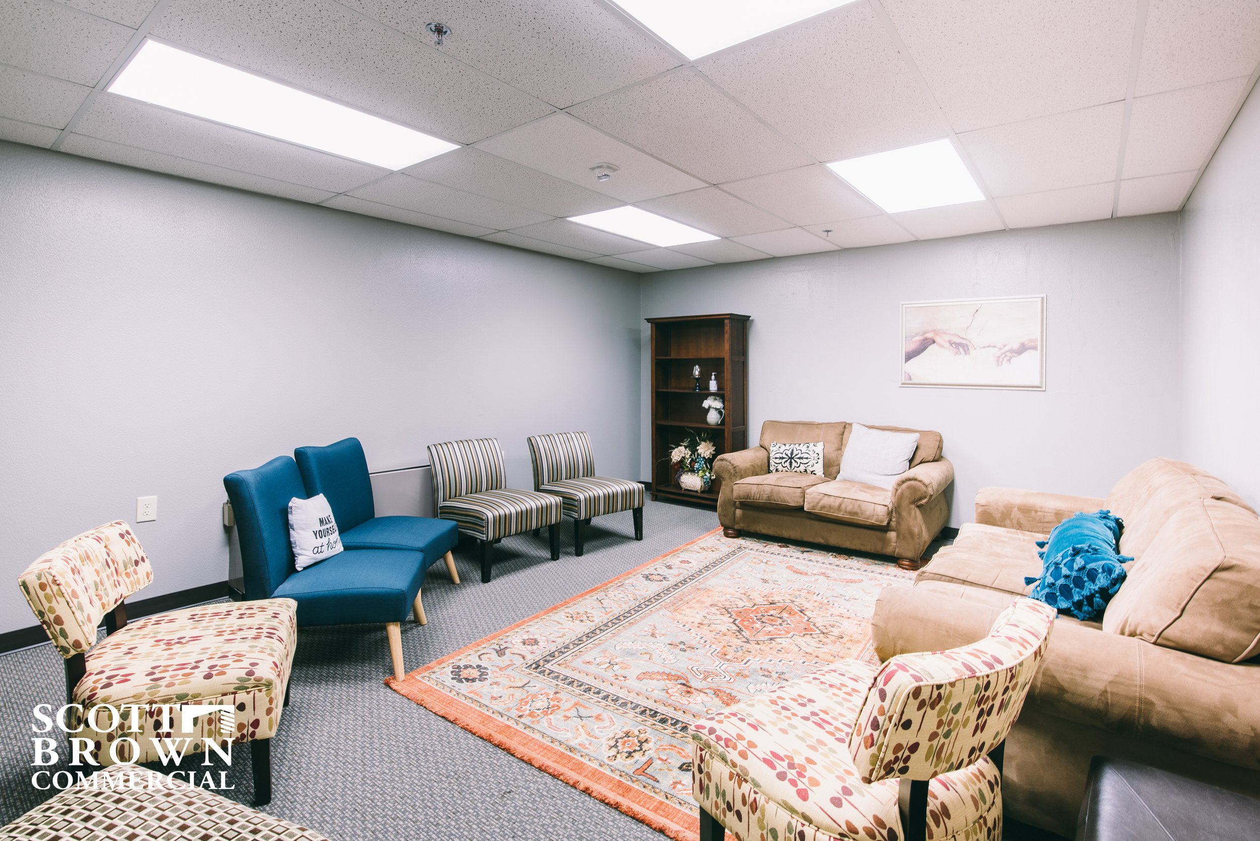  a child/nursing room with couches and plush chairs along all 4 walls 