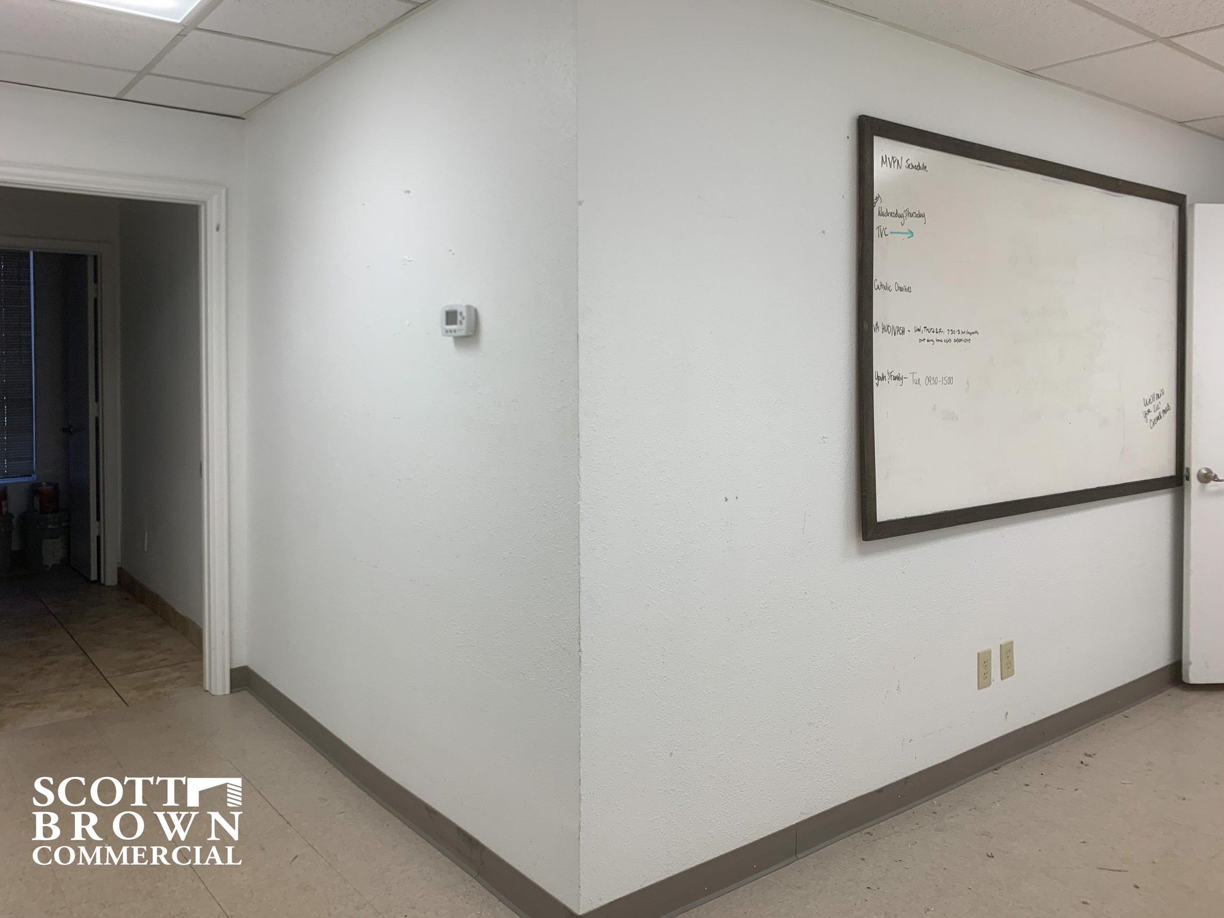  whiteboard on right wall with left leading toward more rooms at 400 S Carroll Boulevard 