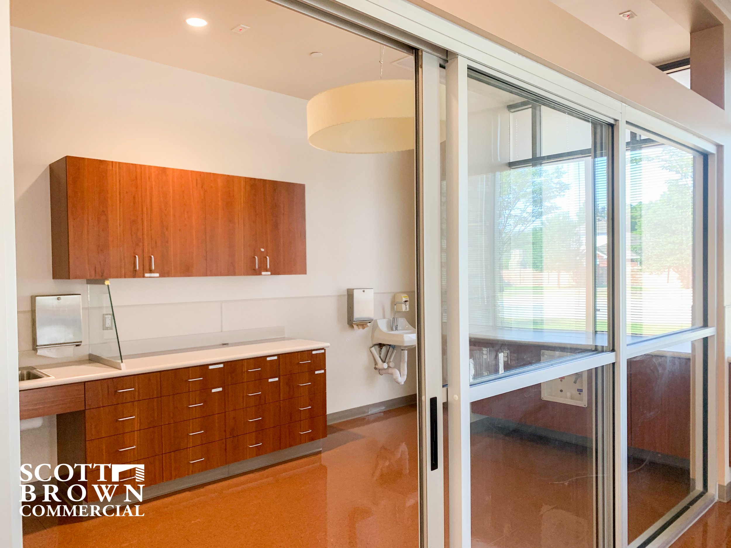  glass doors in front of a room with storage and window 