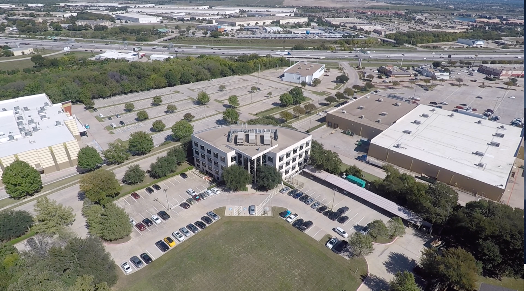  view across the street of 417 Oakbend Drive of a large parking lot 